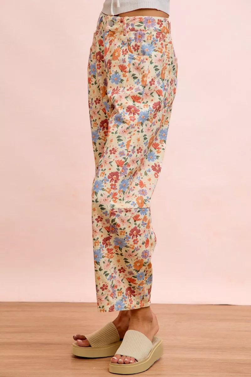 Woman wearing cream floral printed barrel-leg pants by BiBi with cream platform sandals. Side View