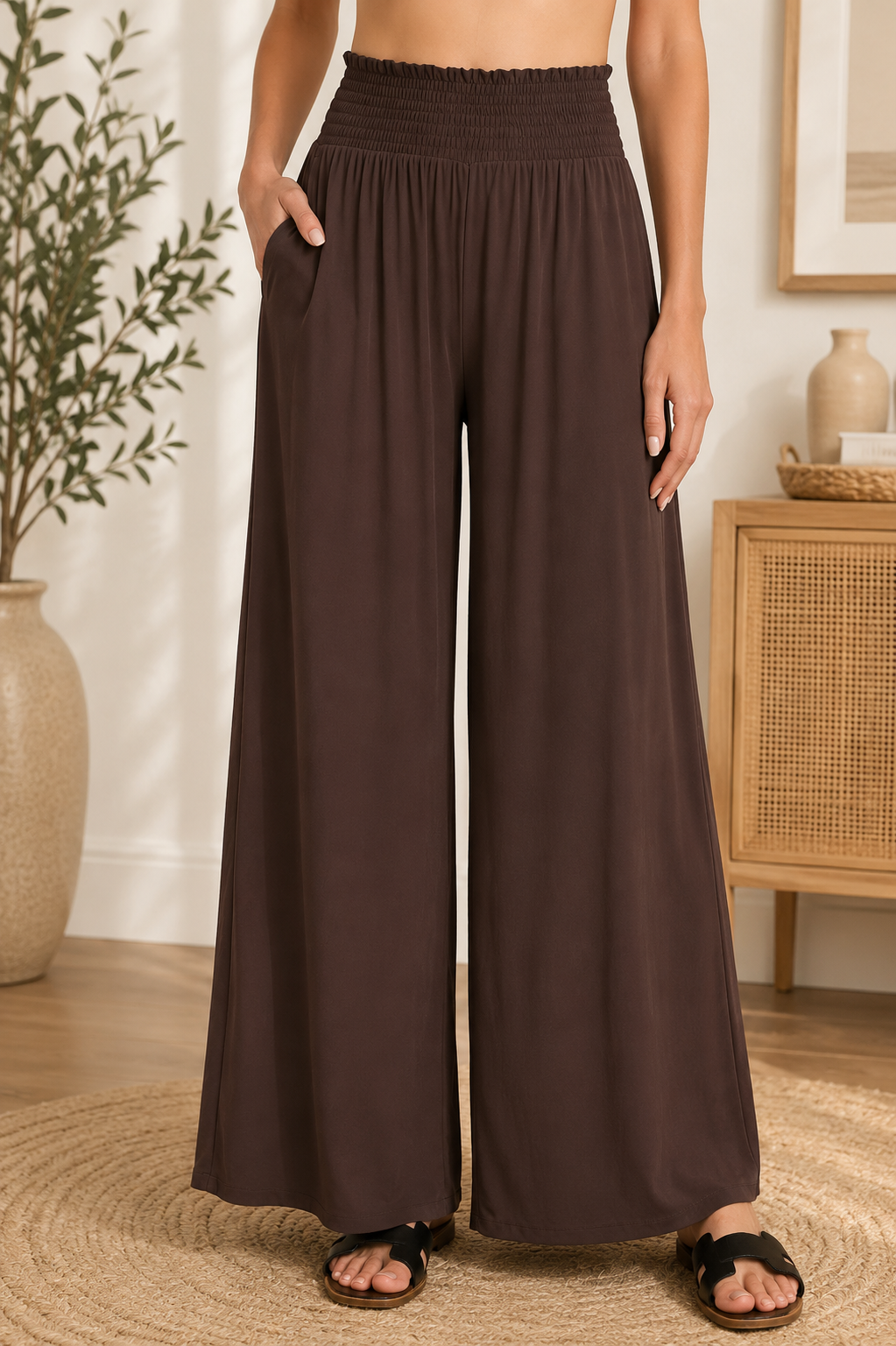 Woman wearing dark brown Zenana smocked waist wide leg palazzo pants with pockets and a flowy relaxed fit.
 Front View