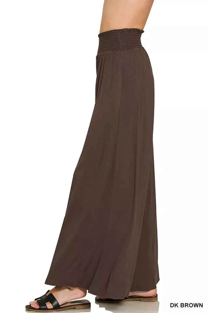 Woman wearing dark brown Zenana smocked waist wide leg palazzo pants with pockets and a flowy relaxed fit.
 Side View
