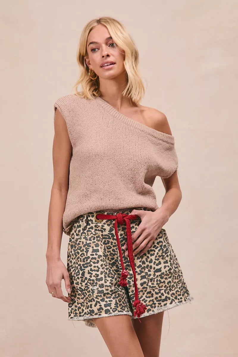 Woman wearing leopard print cotton shorts with a braided tassel waist belt, raw hem, and oversized front patch pockets by BiBi. front view 4