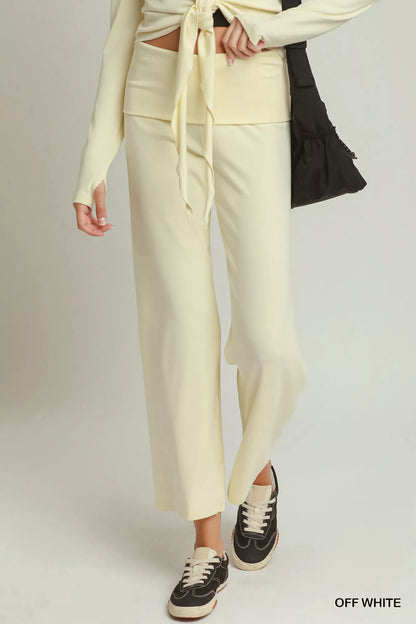 Woman wearing off white straight-leg pants by Umgee styled with black sneakers and a coordinating knit top. Front View