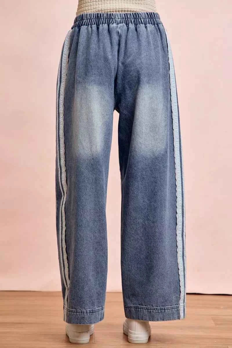 Women's washed denim jeans with lace side panel detailing, relaxed fit silhouette, and vintage-inspired finish by BiBi. Back View
