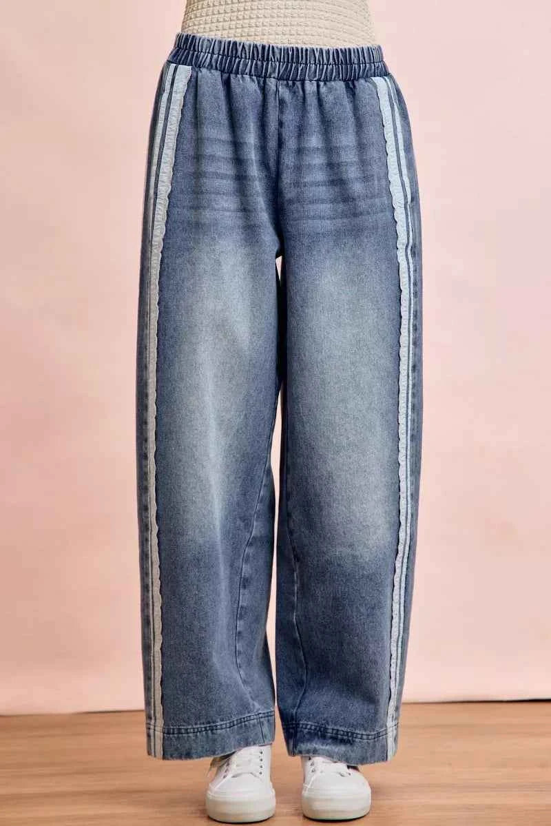 Women's washed denim jeans with lace side panel detailing, relaxed fit silhouette, and vintage-inspired finish by BiBi. Front view