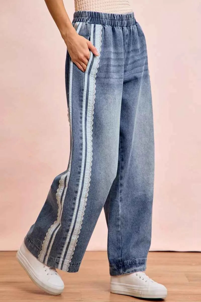 Women's washed denim jeans with lace side panel detailing, relaxed fit silhouette, and vintage-inspired finish by BiBi. Side View