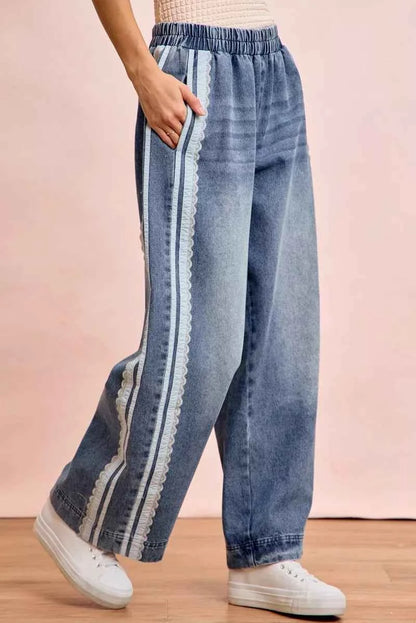 Women's washed denim jeans with lace side panel detailing, relaxed fit silhouette, and vintage-inspired finish by BiBi. Side View