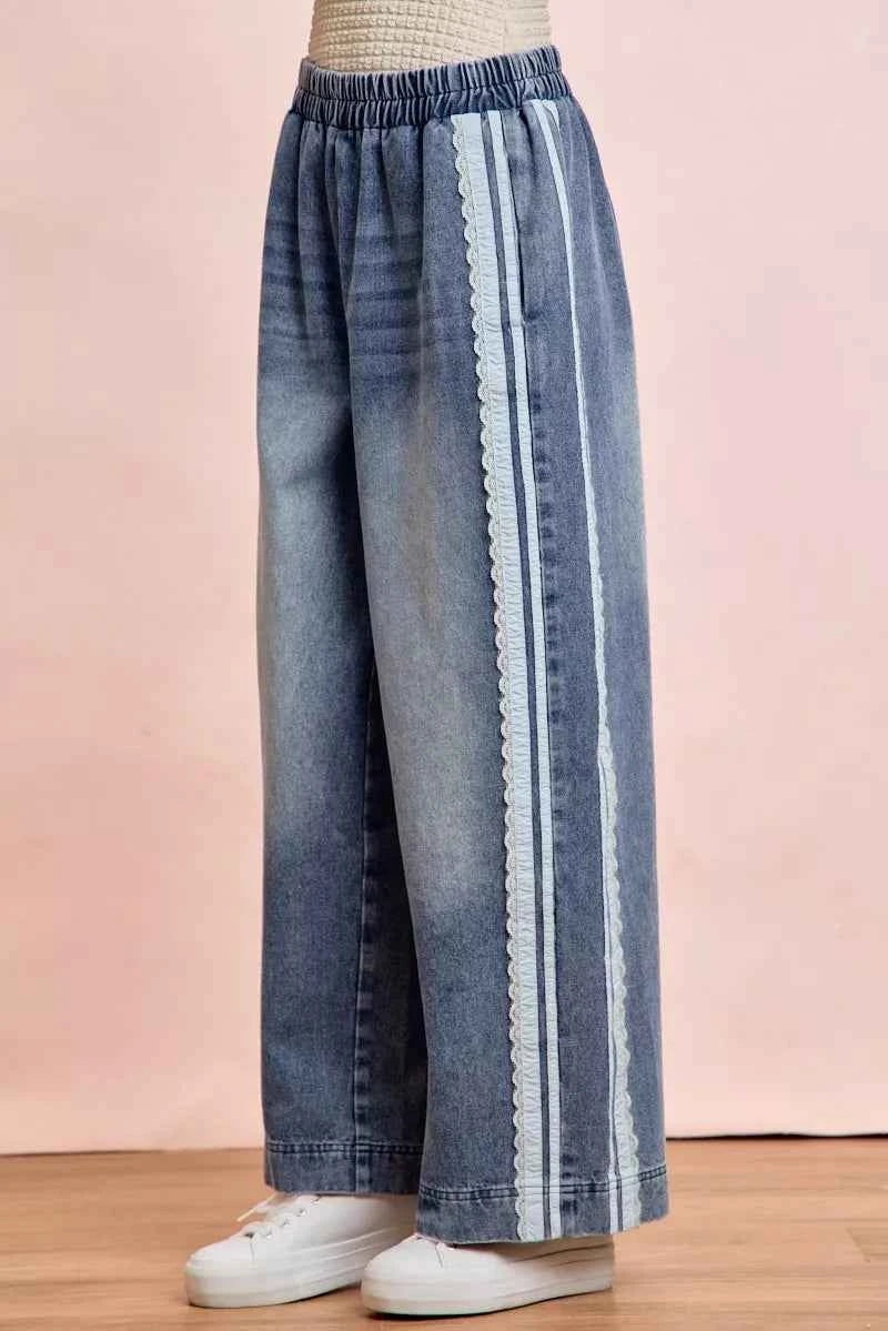 Women's washed denim jeans with lace side panel detailing, relaxed fit silhouette, and vintage-inspired finish by BiBi. Side View 2