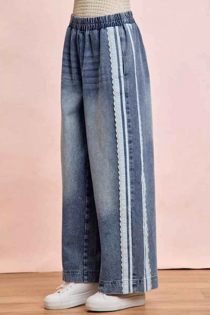 Women's washed denim jeans with lace side panel detailing, relaxed fit silhouette, and vintage-inspired finish by BiBi. Side View 2